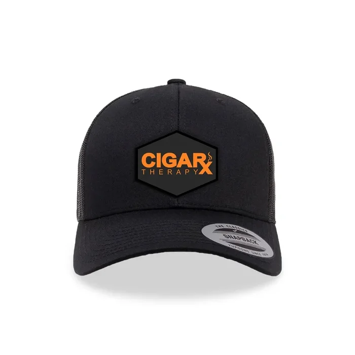 Black Trucker Cap with Orange Embroidered Patch on Black Background